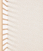 A close up of the Linen rice print Little Green Sheep Organic Cot & Cot Bed Fitted Sheet in a cot