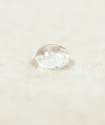 A close up of a water droplet on the Little Green Sheep Organic Moses Basket / Pram Mattress Protector