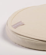 A close up of the corder of a Little Green Sheep Organic Moses Basket / Pram Mattress Protector