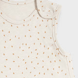 A close up of the popper closure on the shoulder of the Little Green Sheep Organic Baby Sleeping Bag 1.0 Tog in Linen Rice print