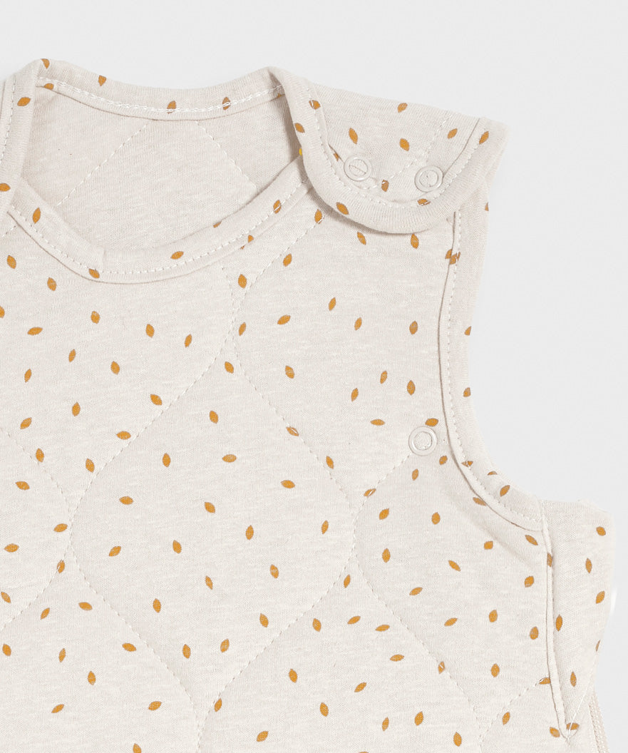 A close up of the popper closure on the shoulder of the Little Green Sheep Organic Baby Sleeping Bag 2.5 Tog in a Linen Rice print