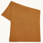 Little Green Sheep Organic Knitted Cellular Baby Blanket in a honey yellow colour on a plain background 