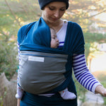 Adult carrying a baby in the Love Radius Original JPMBB Baby Wrap - peacock blue/elephant.