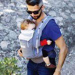 An adult carrying a baby in the Love Radius PhysioCarrier in Elephant.