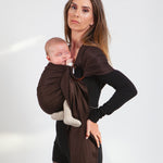 A parent wearing their baby in a espresso brown coloured Love Radius No Knot Woven Wrap. A wide range of baby wraps and carriers are available at Babipur. 