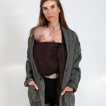 A parent wearing their baby in a espresso brown coloured Love Radius No Knot Woven Wrap. The baby is asleep. A wide range of baby wraps and carriers are available at Babipur. 