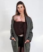 A parent wearing their baby in a espresso brown coloured Love Radius No Knot Woven Wrap. The baby is asleep. A wide range of baby wraps and carriers are available at Babipur. 