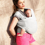 Adult carrying a baby in the Love Radius Organic Baby Wrap in Pearl. 