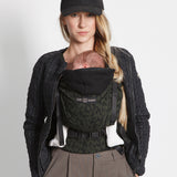 An adult carrying a baby in the Love Radius HoodieCarrier 2 - Wild Camo. 