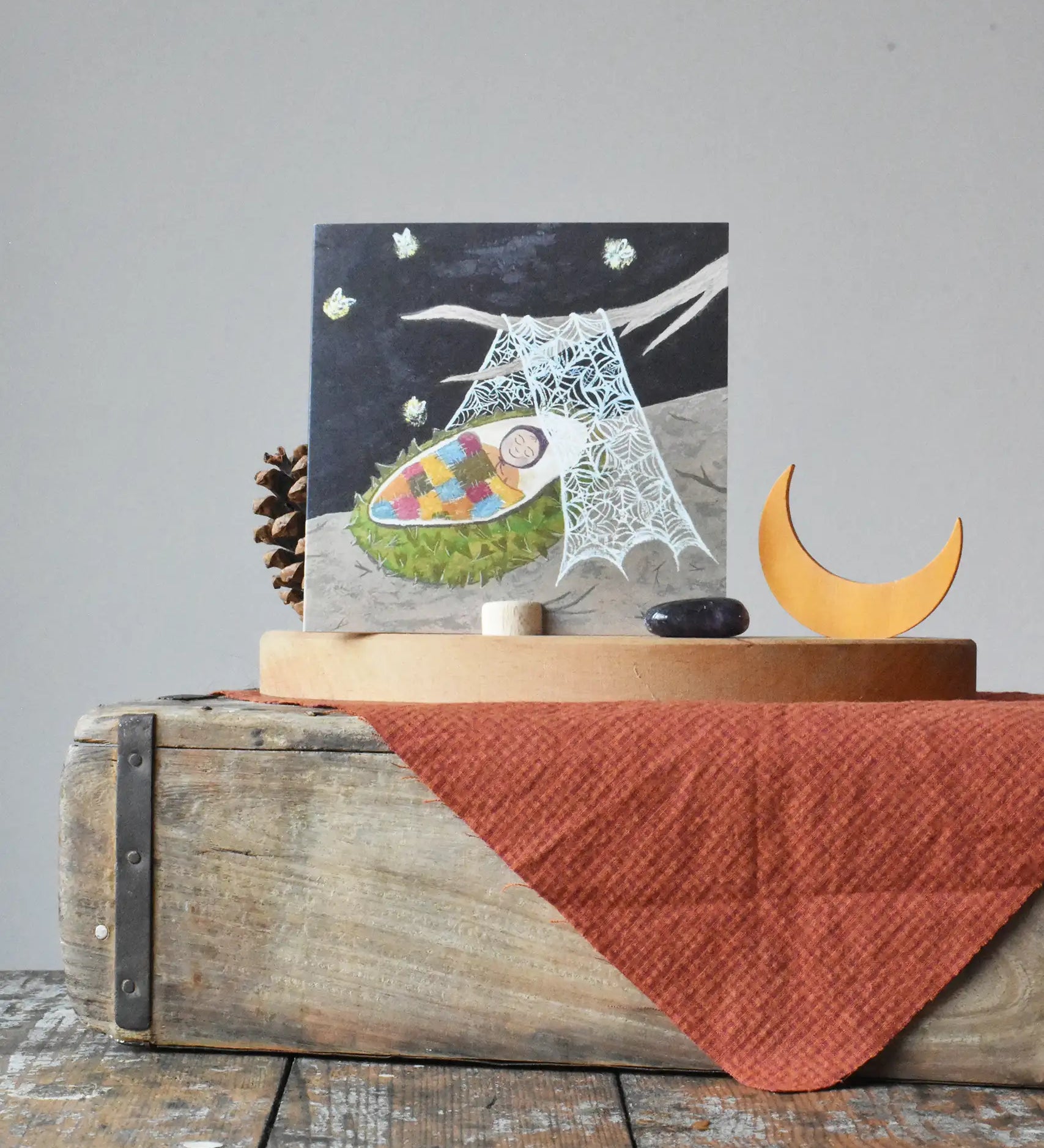 LydiaMae conker baby greetings card placed in a photo holder on a Grimm's celebration ring next to a moon decorative figure.
