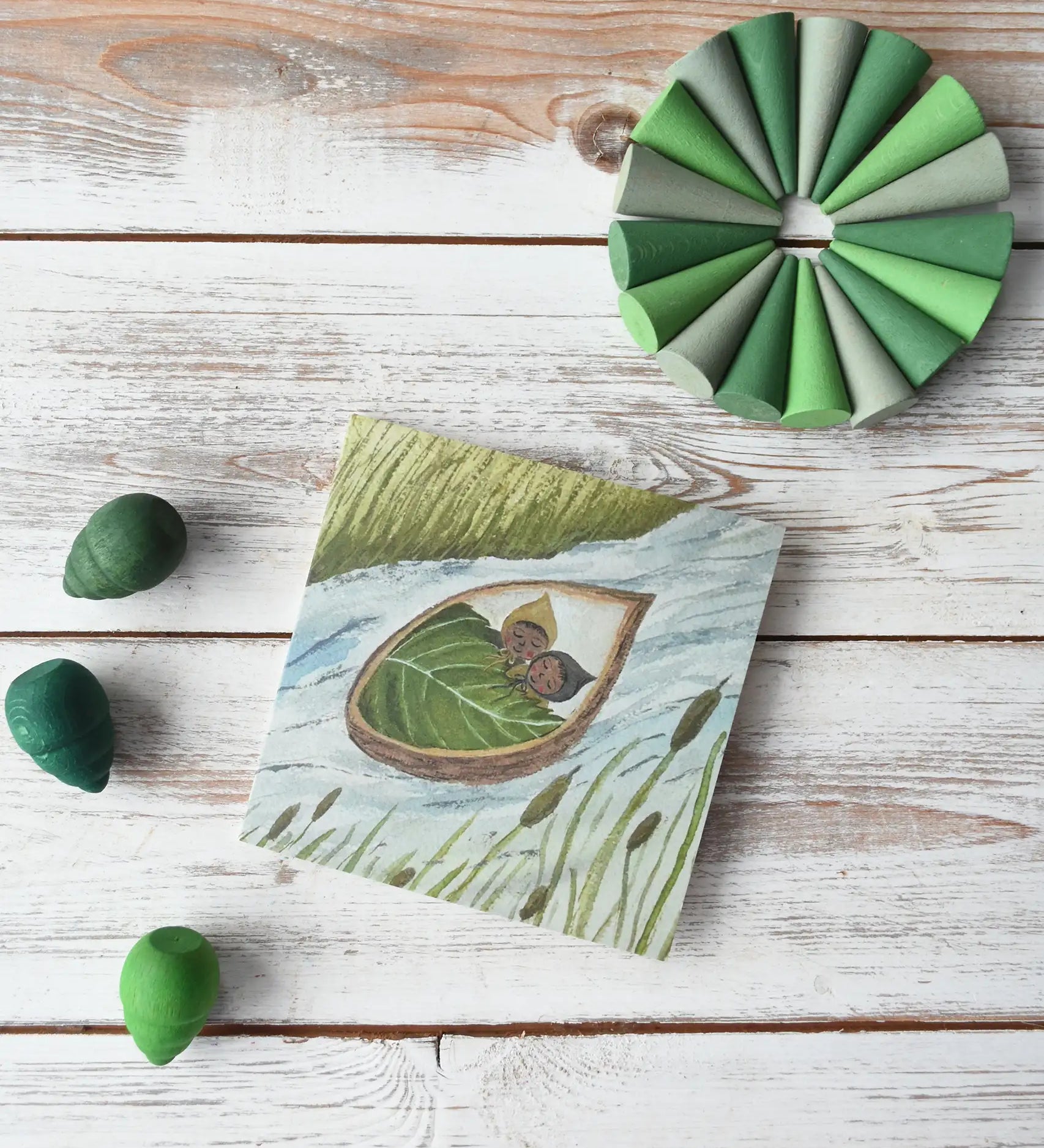 LydiaMae in a nutshell twins greetings card placed in teh middle of a flatlay with green coloured Grapat mandala pieces. 