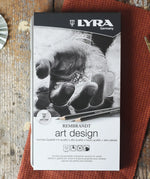 Lyra 12 drawing pencils in sizes from 6B to 4H in a metal storage tin.