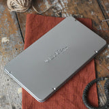 Lyra 12 drawing pencils in sizes from 6B to 4H in a metal storage tin.