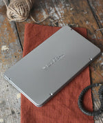 Lyra 12 drawing pencils in sizes from 6B to 4H in a metal storage tin.