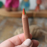 Close up of Lyra super Ferby 4 colour triangular rainbow pencil in an adult's hand.