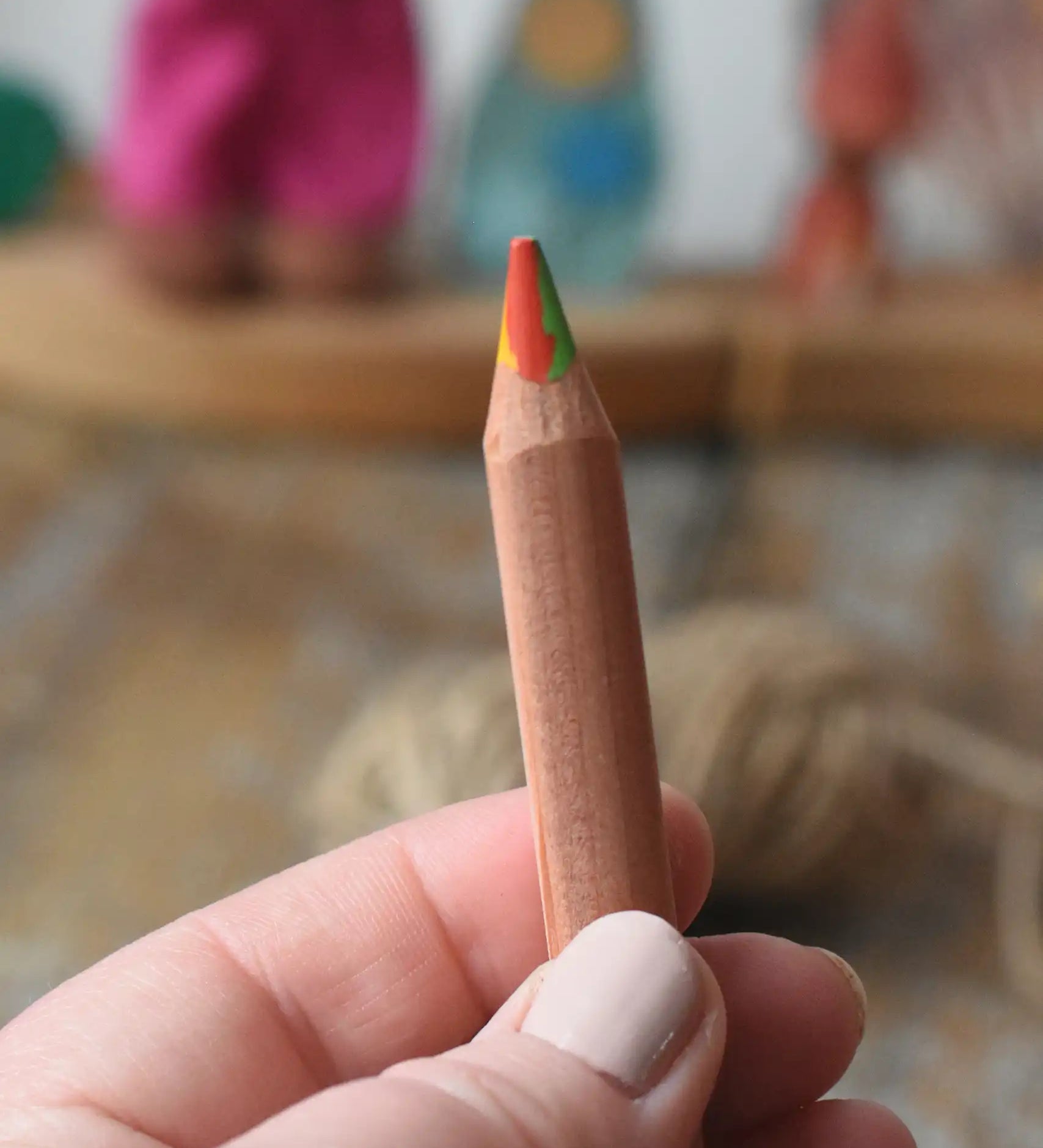 Close up of Lyra super Ferby 4 colour triangular rainbow pencil in an adult's hand.