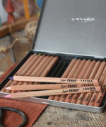 Lyra 18 standard colour triangular Super Ferby pencil set in their metal storage tin. Three pencils have been taken out