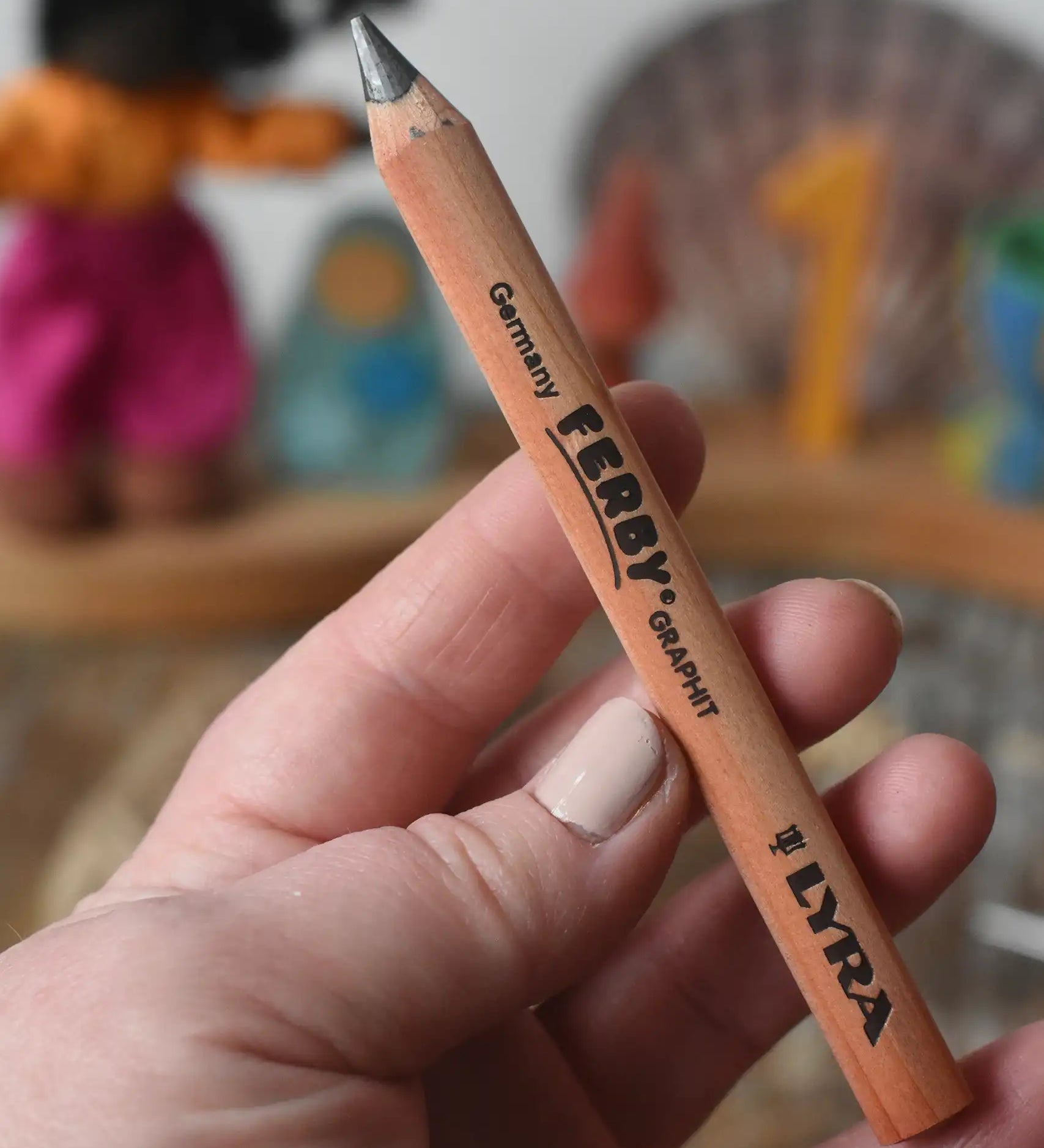 Lyra Ferby triangular shaped graphite HB pencil in an adult's hand.