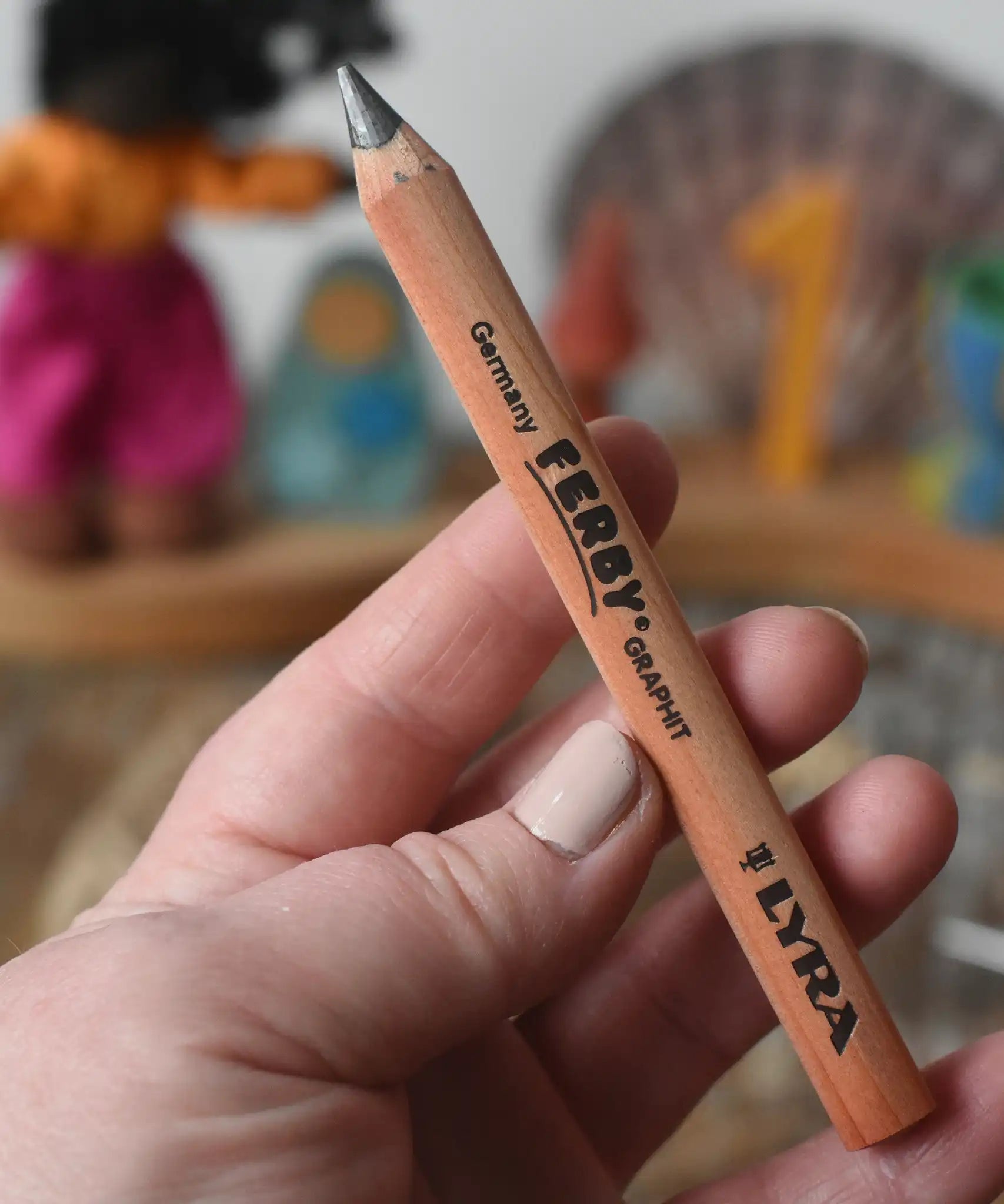 Lyra Ferby triangular shaped graphite HB pencil in an adult's hand.