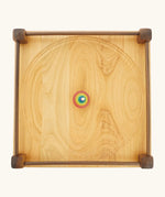 Mader Kreiselmanufaktur Manège wooden spinning plate. Overhead shot of rallye spinning top placed in the middle.