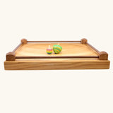 Side on view showing the walnut wood sides on the Mader Kreiselmanufaktur Manège wooden spinning plate.