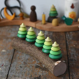Mader Kreiselmanufaktur 5 tree spinning tops on branch placed on a wooden desk in the Babipur playroom.
