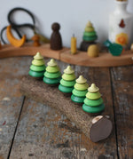 Mader Kreiselmanufaktur 5 tree spinning tops on branch placed on a wooden desk in the Babipur playroom.