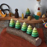 Mader Kreiselmanufaktur 5 tree spinning tops on branch placed on a wooden desk in the Babipur playroom.