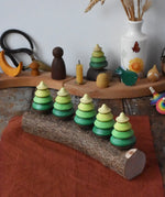 Mader Kreiselmanufaktur 5 tree spinning tops on branch placed on a wooden desk in the Babipur playroom.