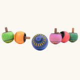 Different colours of Mader Kreiselmanufaktur Arabesk Turn-Over Wooden Spinning Tops, colour chosen at random.