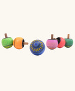 Different colours of Mader Kreiselmanufaktur Arabesk Turn-Over Wooden Spinning Tops, colour chosen at random.