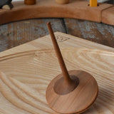 Mader ballerina wooden spinning top  placed on an ash spinning plate in the Babipur playroom. 