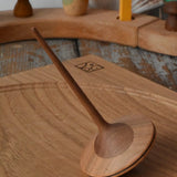 Mader ballerina wooden spinning top placed on an oak spinning plate in the Babipur playroom. 