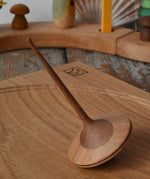 Mader ballerina wooden spinning top placed on an oak spinning plate in the Babipur playroom. 