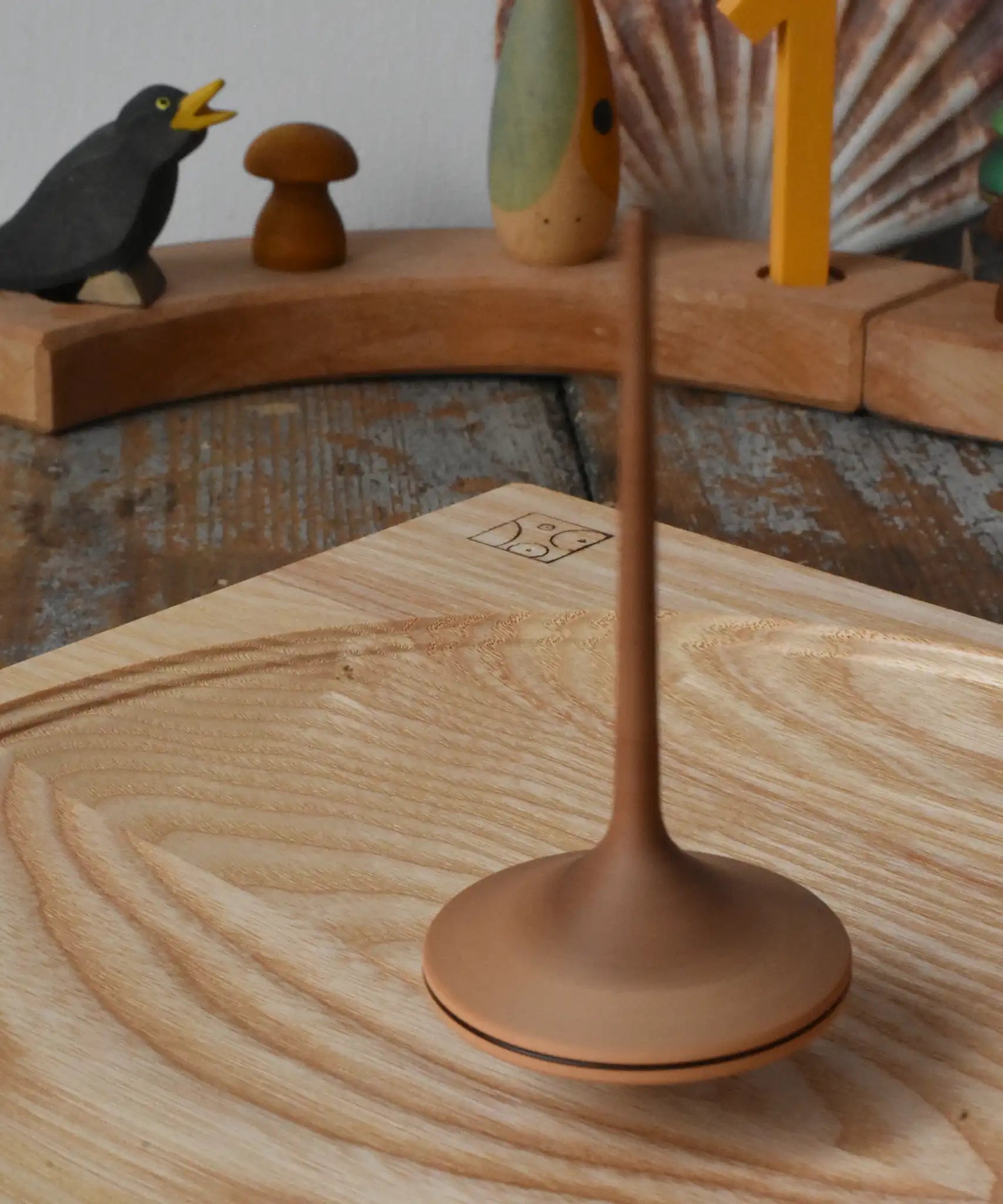 Mader ballerina wooden spinning top spinning in motion on an ash spinning plate in the Babipur playroom. 
