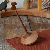 Mader ballerina wooden spinning top placed on a desk in the Babipur playroom.