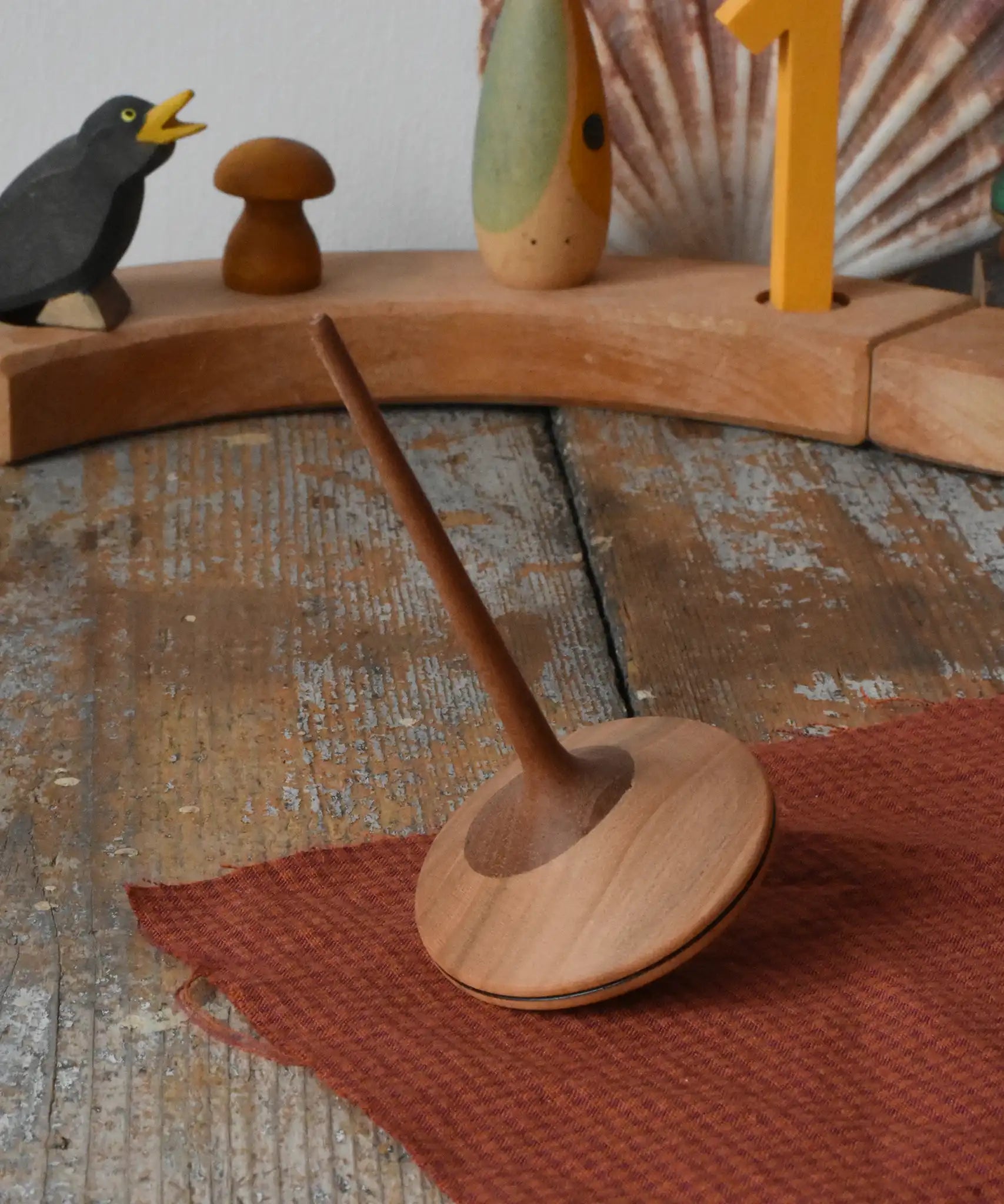 Mader ballerina wooden spinning top placed on a desk in the Babipur playroom.