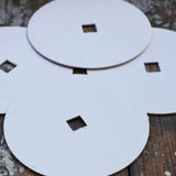 Mader 4 Replacement Discs for 'So And So' Spinning Top Set placed on a wooden surface.
