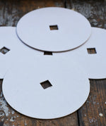 Mader 4 Replacement Discs for 'So And So' Spinning Top Set placed on a wooden surface.