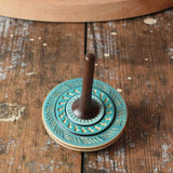 Blue Mader Kreiselmanufaktur bonbon wooden spinning top placed on a wooden desk in the Babipur playroom.