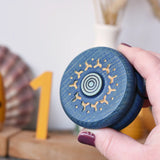 Mader burlesk wooden yoyo in blue in an adult hand. 