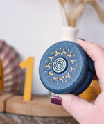 Mader burlesk wooden yoyo in blue in an adult hand. 