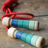 Mader Skipping Rope with Blue Handles placed on a wooden board in the Babipur playroom.