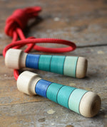 Mader Skipping Rope with Blue Handles placed on a wooden board in the Babipur playroom.