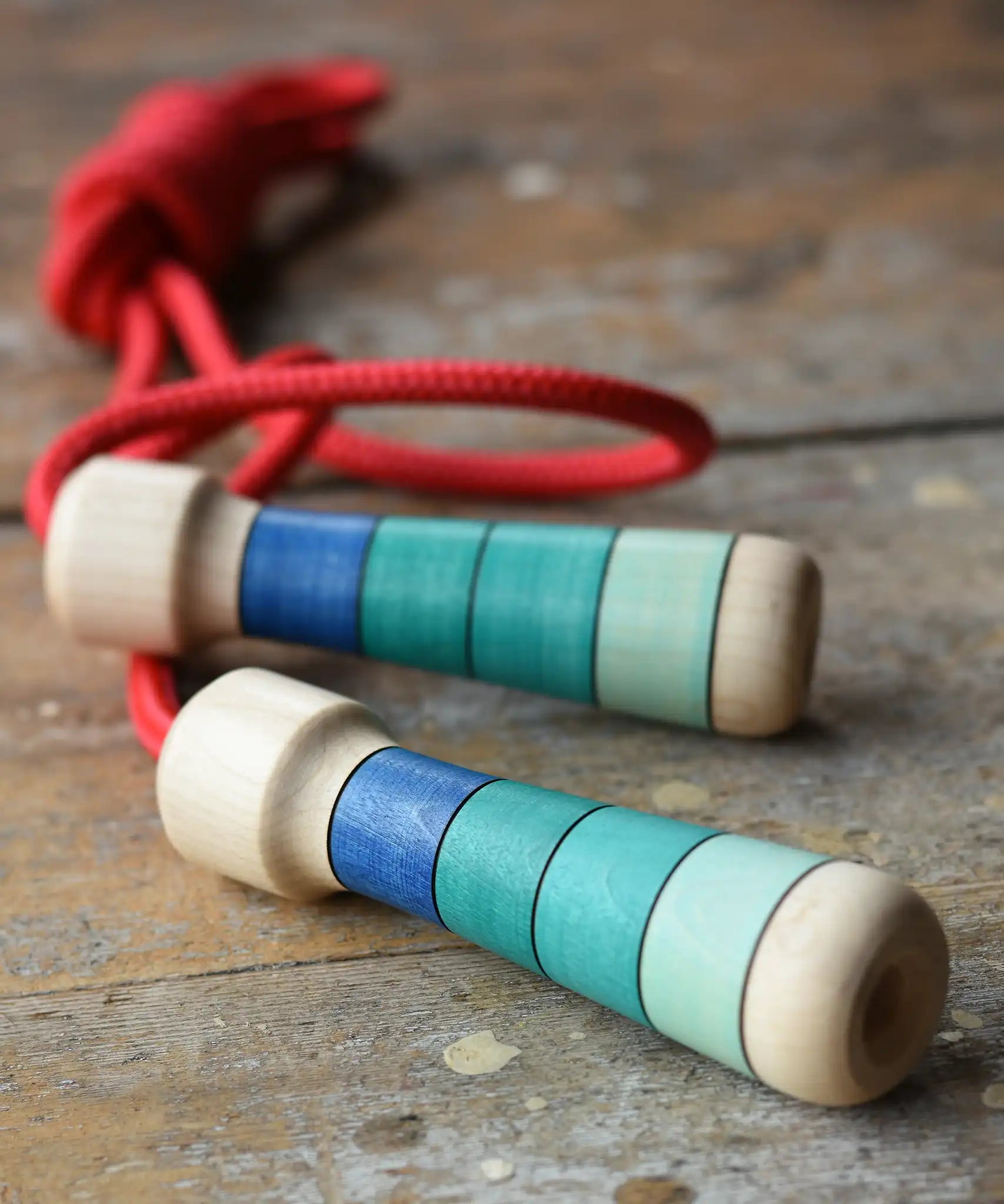 Mader Skipping Rope with Blue Handles placed on a wooden board in the Babipur playroom.