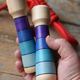 Mader Kreiselmanufaktur Children's Skipping Rope with Purple Handles in an adult's hand. 