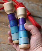 Mader Kreiselmanufaktur Children's Skipping Rope with Purple Handles in an adult's hand. 