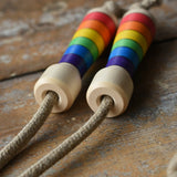 Mader Kreiselmanufaktur Children's Skipping Rope Rainbow Handles placed on a wooden surface in the Babipur playroom.