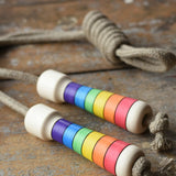 Mader Kreiselmanufaktur Children's Skipping Rope Rainbow Handles placed on a wooden surface in the Babipur playroom.