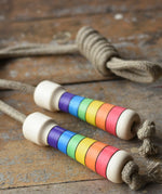 Mader Kreiselmanufaktur Children's Skipping Rope Rainbow Handles placed on a wooden surface in the Babipur playroom.